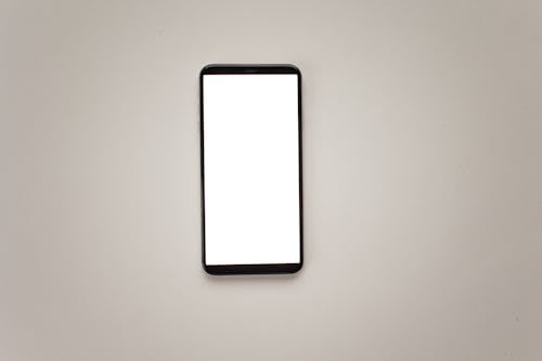 A Smartphone with Blank Screen on White Surface
