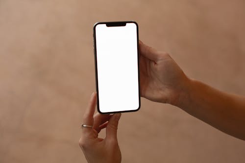 A Person Holding a Smartphone with a Blank Screen