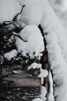 Close-up of snow on a wooden surface in Estonia during winter, highlighting natural textures.