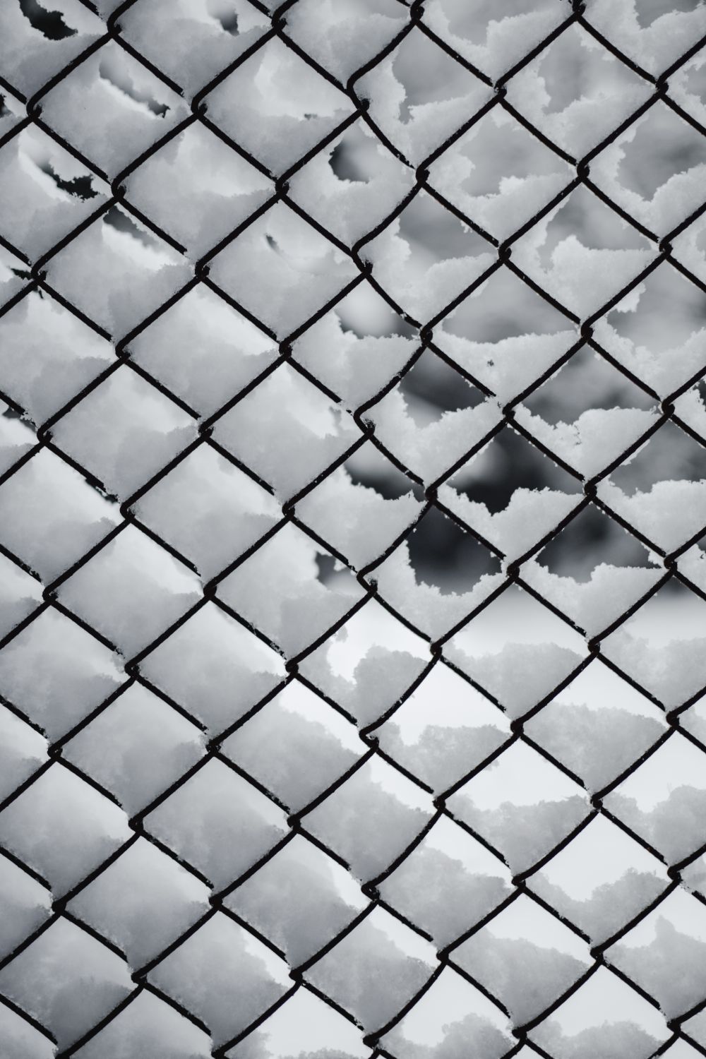 A Black Metal Chain Link Fence Covered with Snow · Free Stock Photo