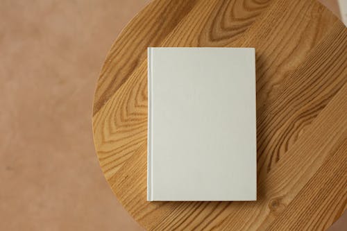 Free Empty white book on wooden table Stock Photo