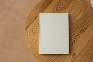 Empty white book on wooden table