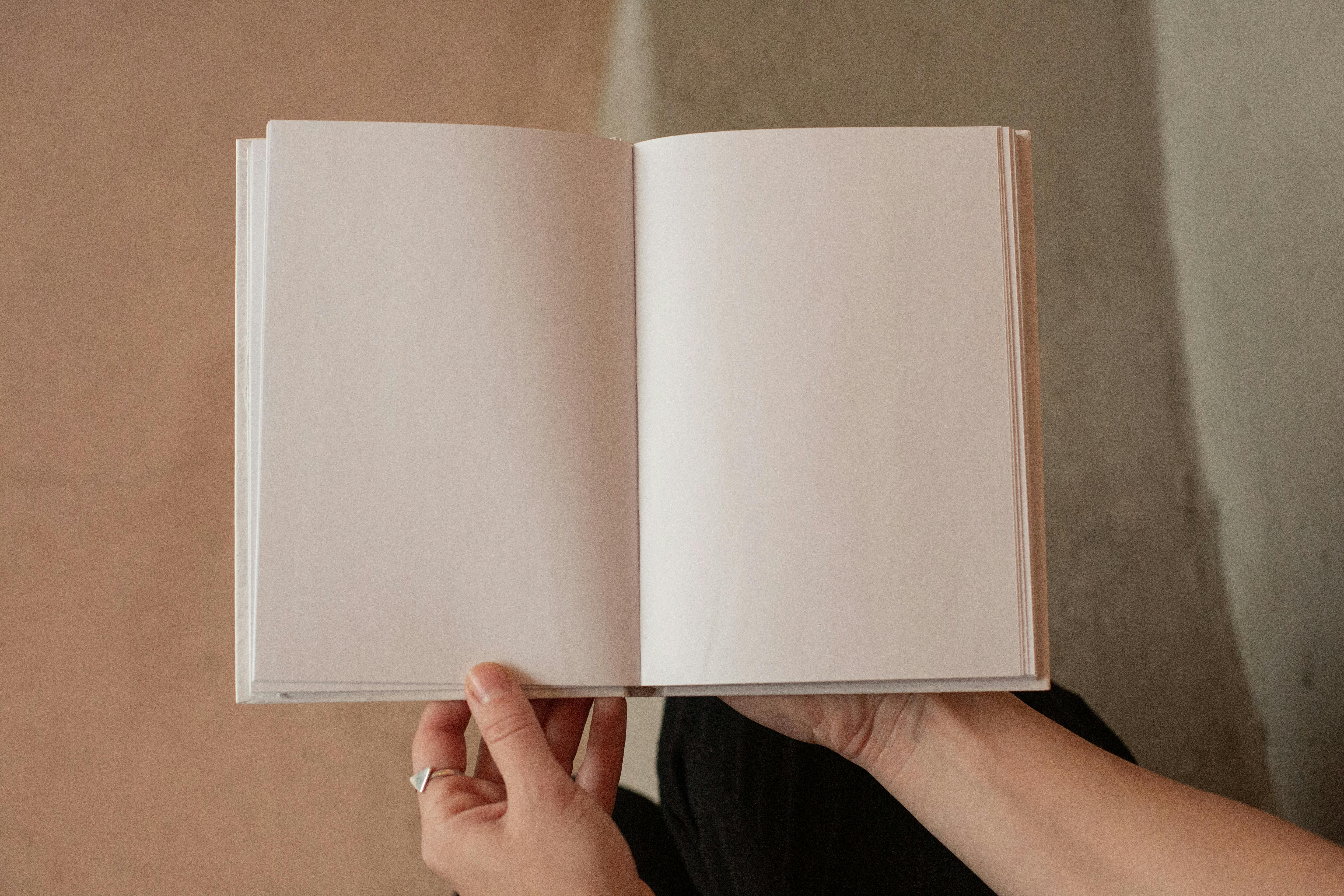 Woman holding book with blank pages · Free Stock Photo