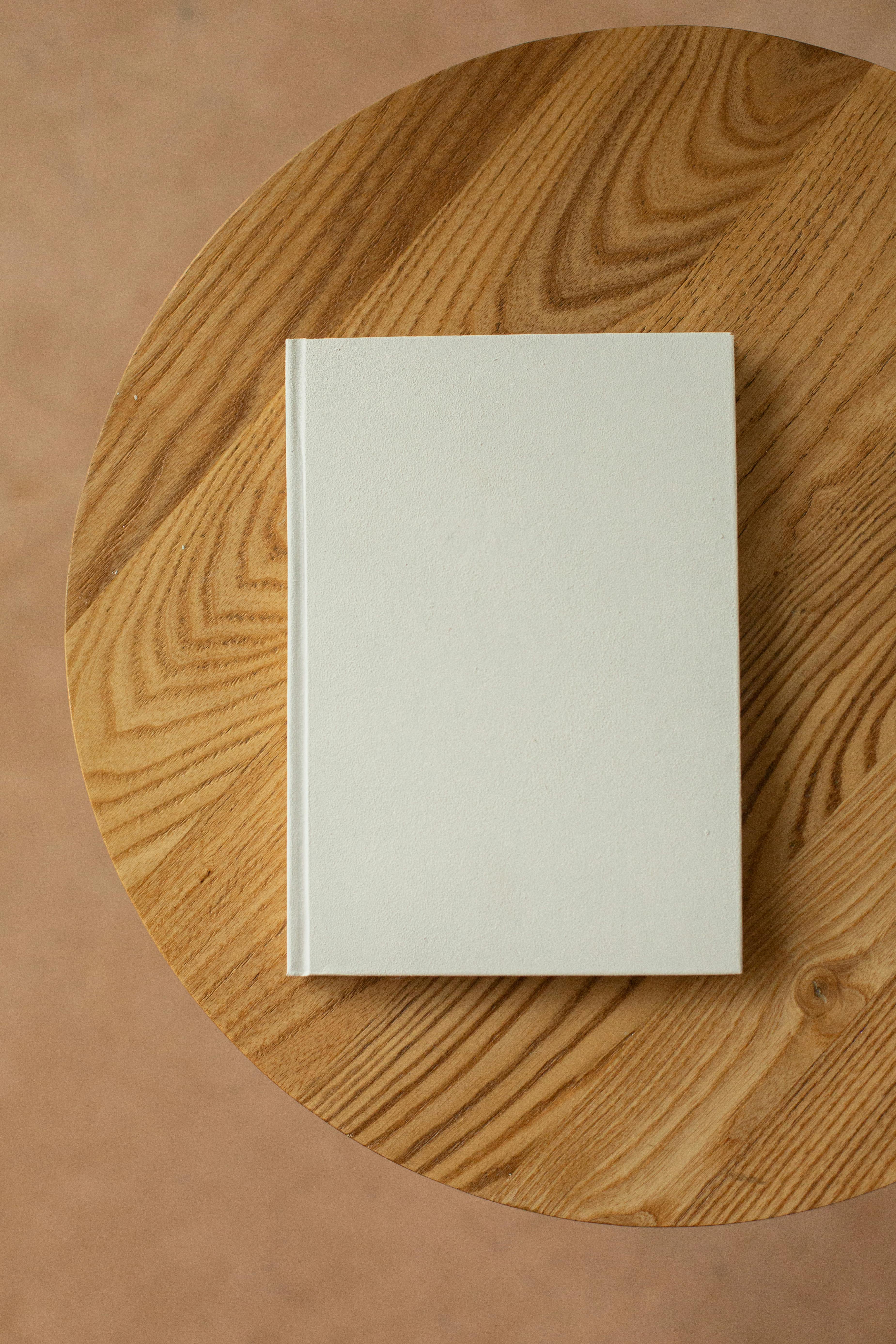 book with white hard cover on table
