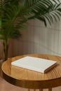 Wooden table with empty hardcovered book
