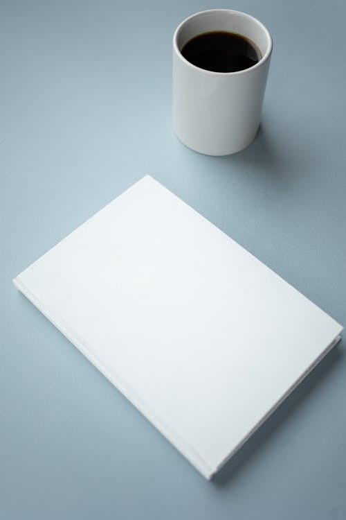 青いテーブルの上の白いプリンター用紙