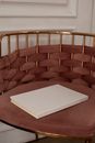 Book with white cover placed on comfortable armchair