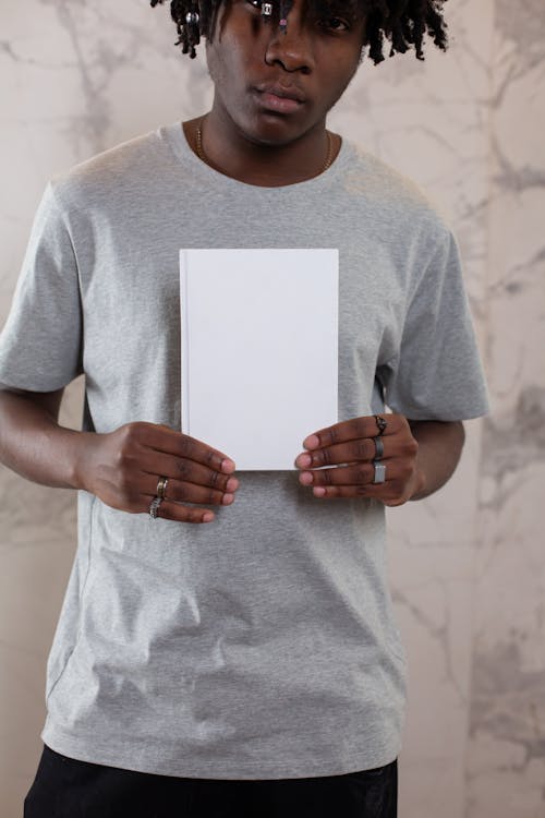 Pensive black man with blank notebook