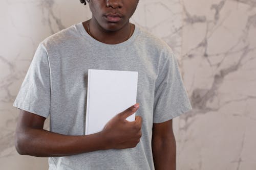 Free Crop black man with mock up notebook Stock Photo