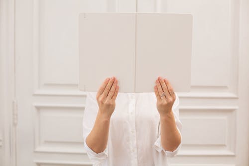 Anonymous woman with opened blank book