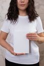 Crop woman showing blank notepad