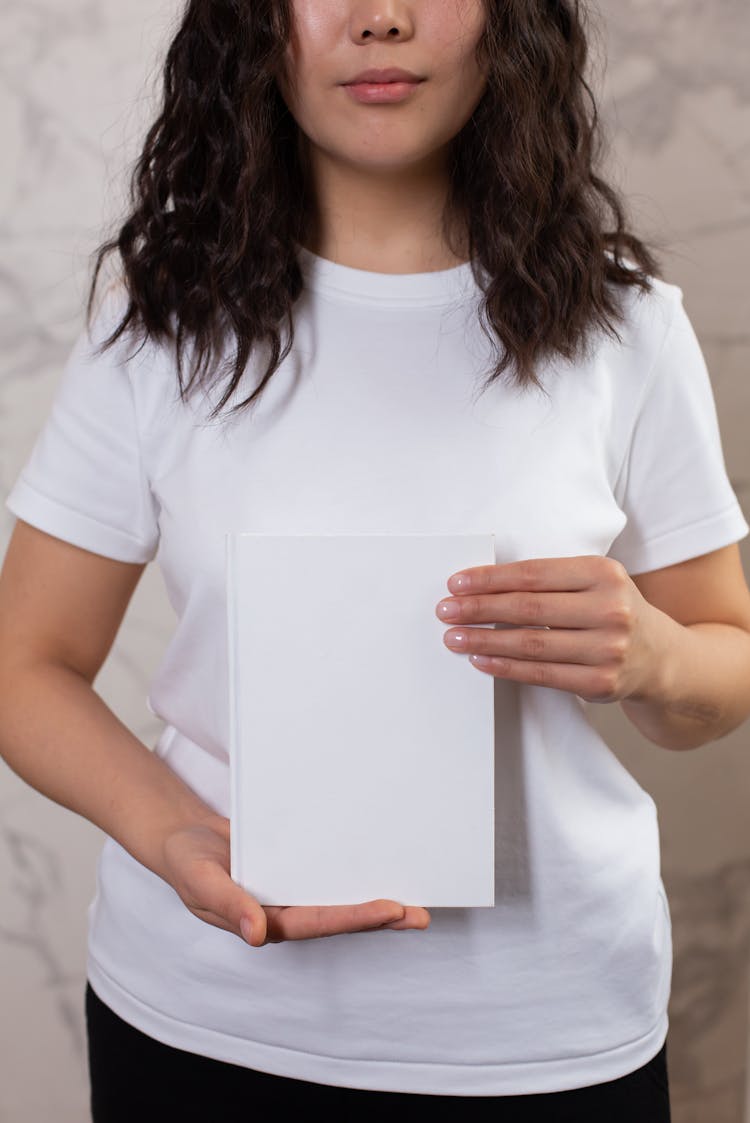 Crop Woman Showing Blank Notepad