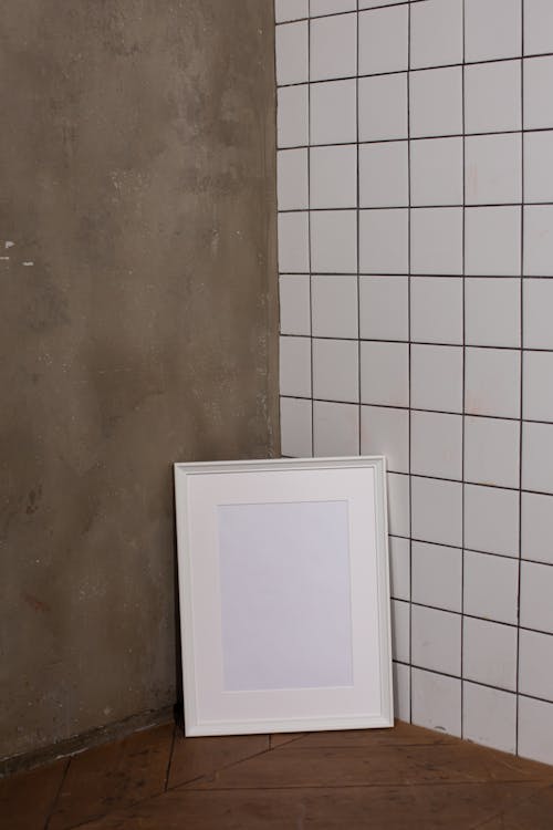 Empty white frame near wall