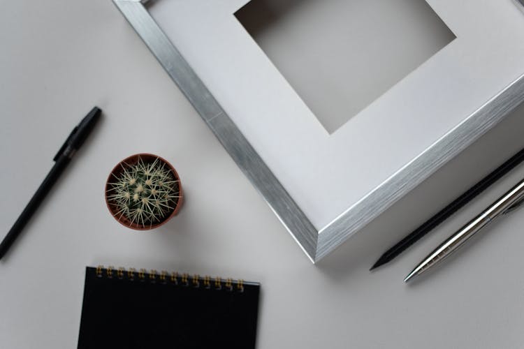 Empty Photo Frame And Stationery On Desk