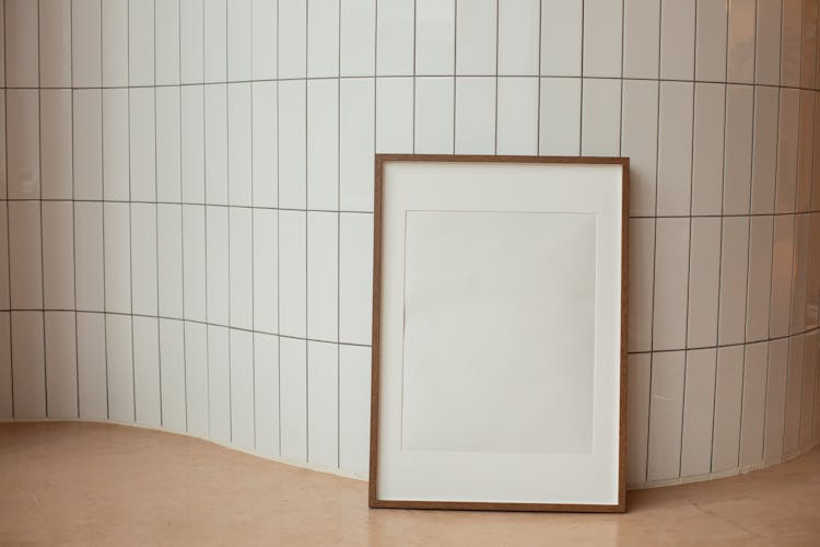 Rectangular Empty Photo Frame Against Tiled Wall