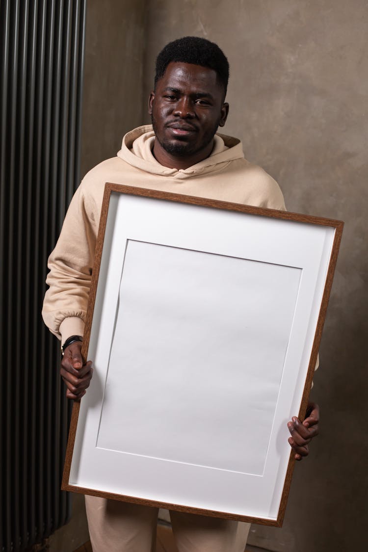 Black Man Holding Big Empty Photo Frame