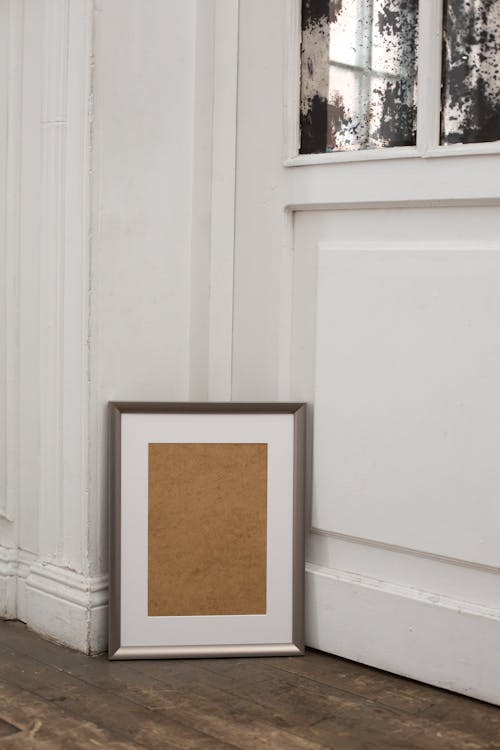 Classic interior of apartment with empty frame on floor