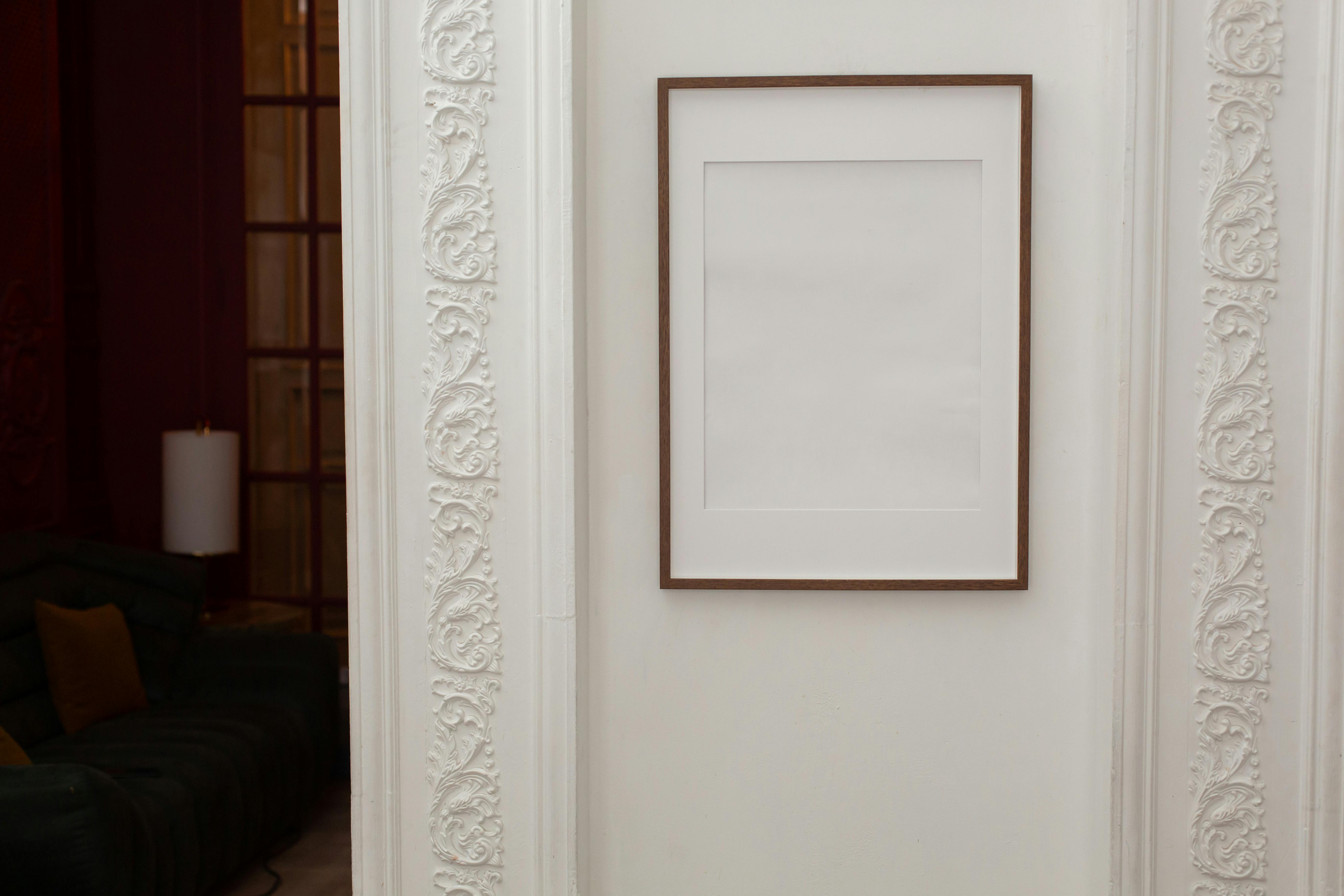 empty white frame hanging on wall with patterns