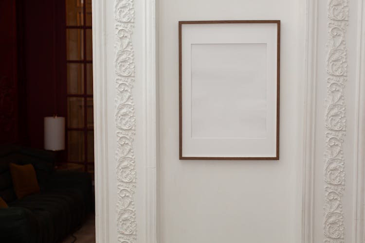 Empty White Frame Hanging On Wall With Patterns