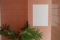Blank poster hanging on wall with ceramic tile