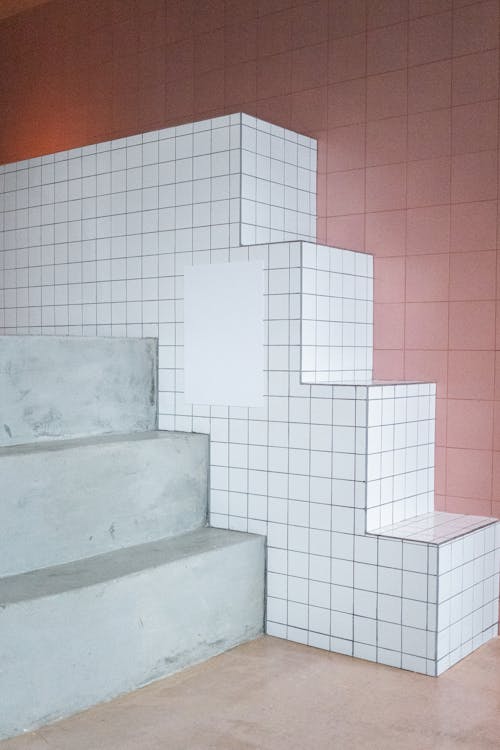 Empty white paint placed on decorative wall in form of stairs in light room with minimalistic design