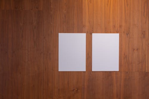 White boards placed near each other on wooden wall in light studio
