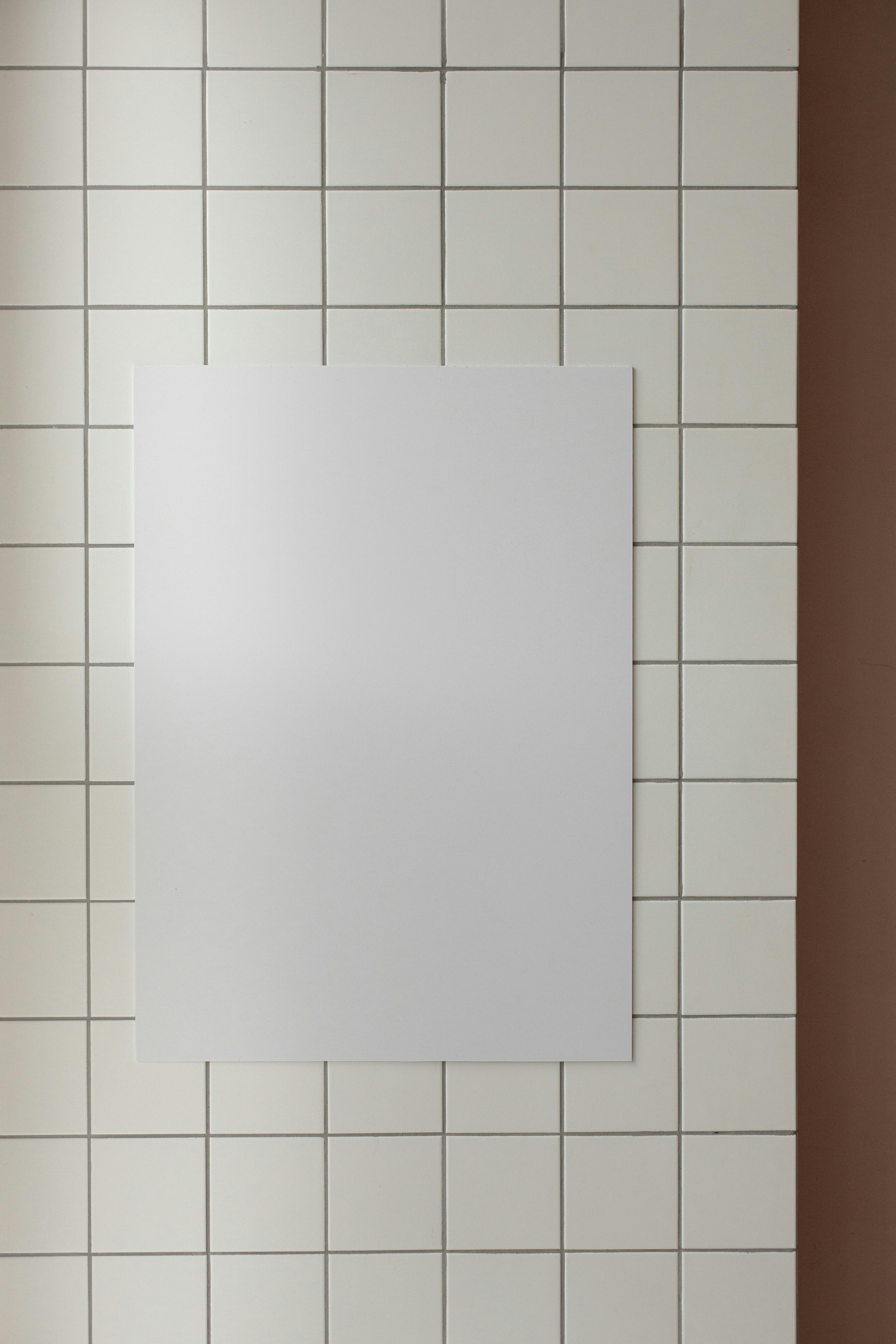 white board on tile wall in room