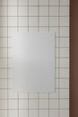 Bright empty room interior with white blank canvas placed on white tile wall