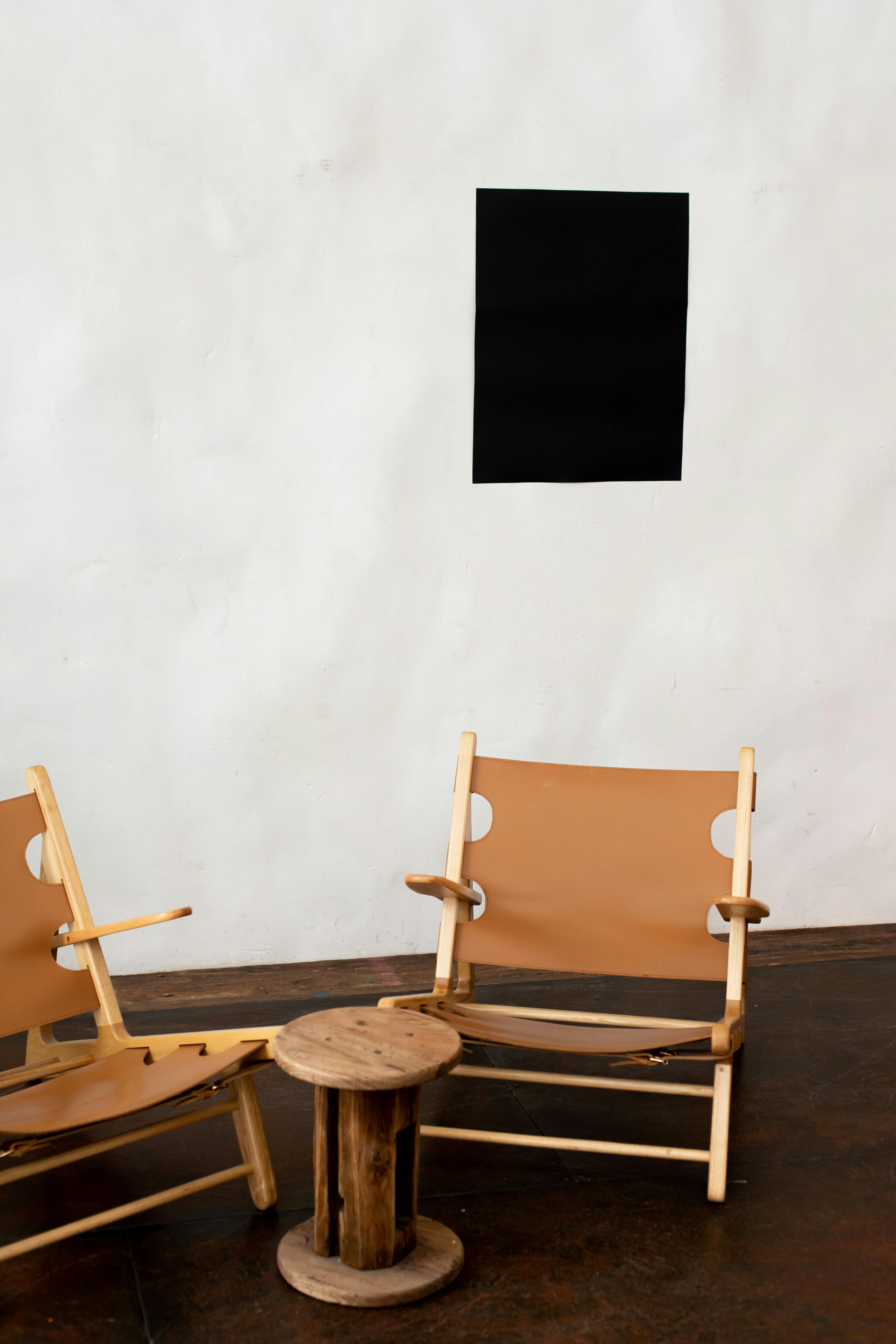 interior of room with armchairs and empty black poster