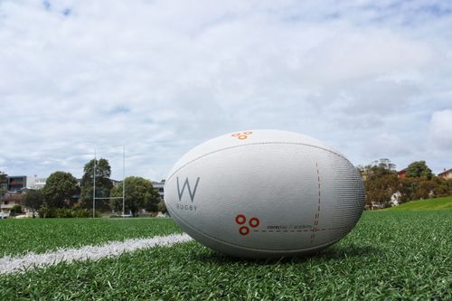 Free A detailed shot of a rugby ball on a green sports field, perfect for sports equipment themes. Stock Photo