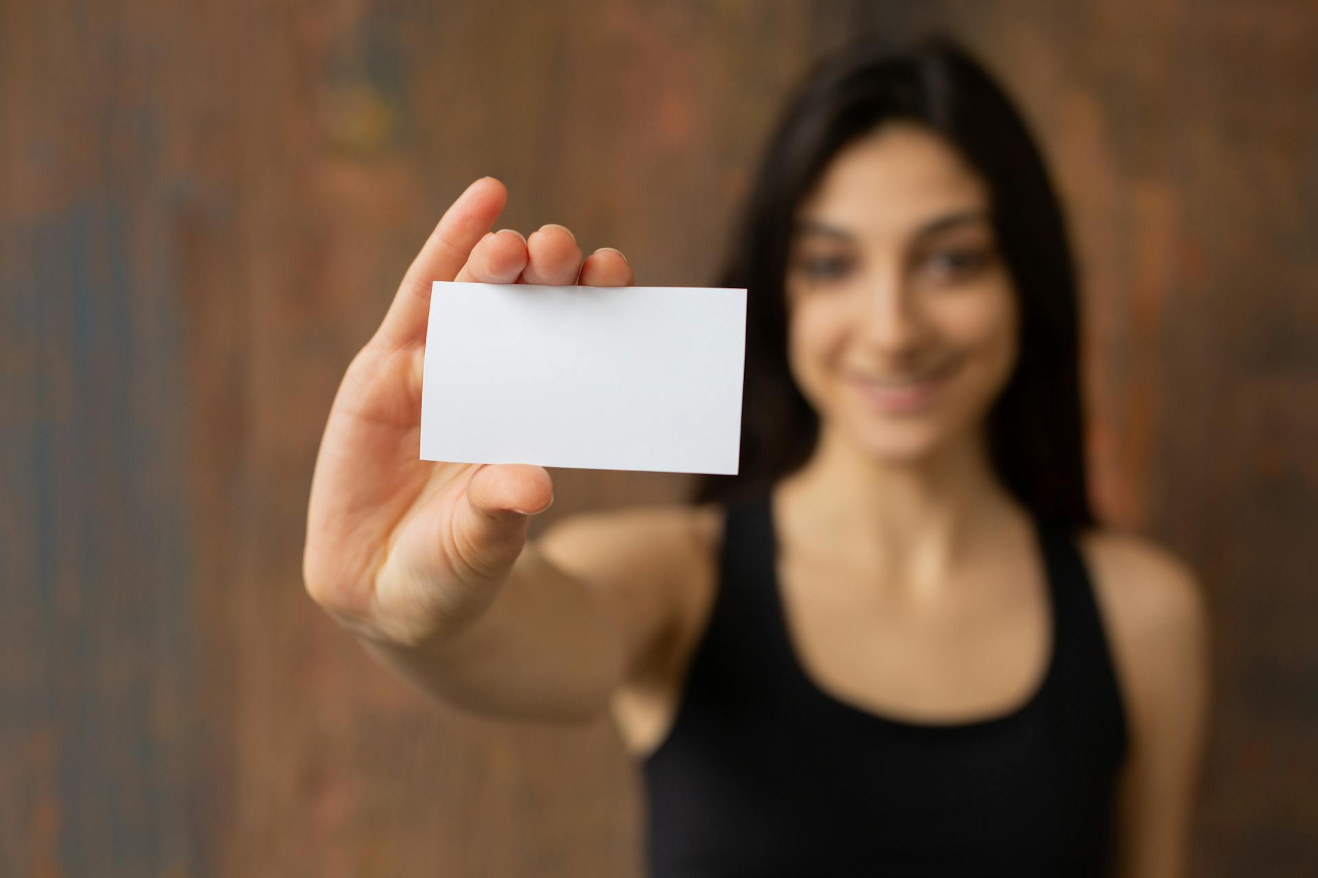 Smiling ethnic woman with mock up business card