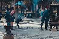 People Standing on the Street while Holding Torches