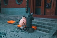 Woman and Girl Praying Outside Temple