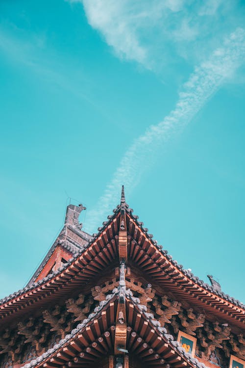 Free Ancient House Roof against Blue Sky Stock Photo