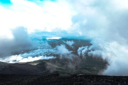 Free Stunning aerial view of a volcanic landscape shrouded in clouds showcasing nature's grandeur. Stock Photo