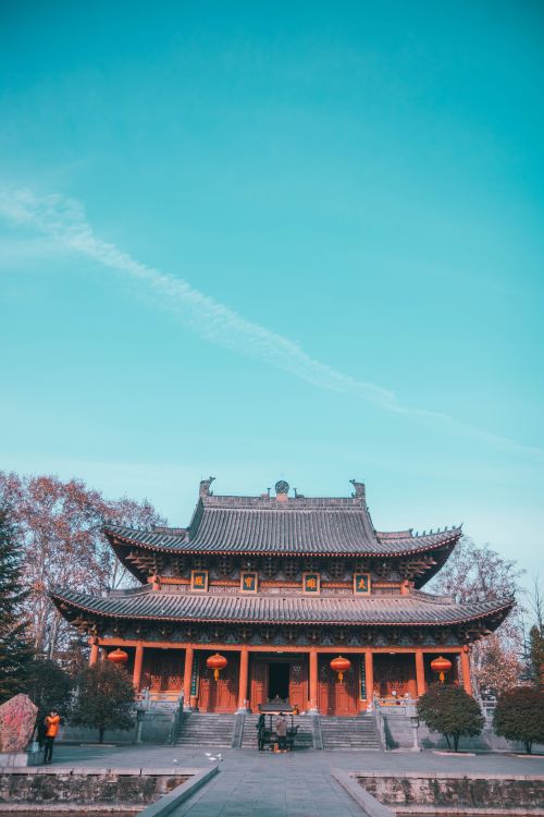 Free A traditional pagoda temple captured under a clear blue sky, highlighting its architectural beauty. Stock Photo