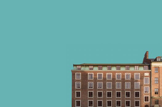 Minimalist view of a historic building facade in Copenhagen with clear blue sky.