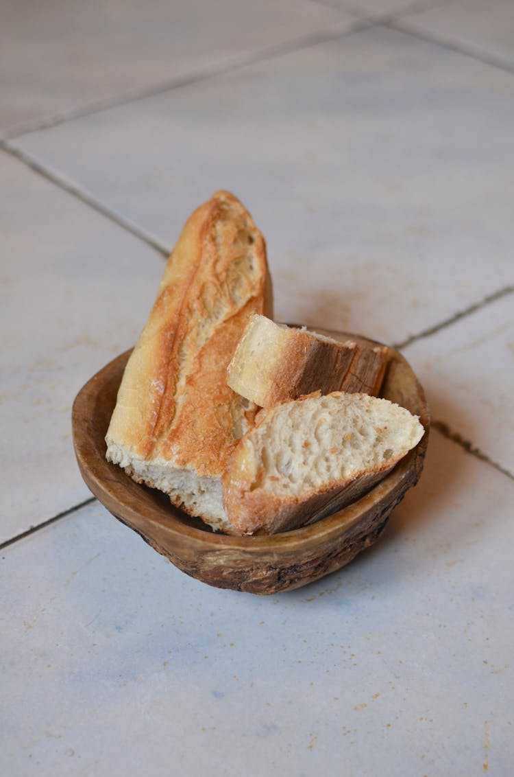 Fresh Cut Bread In Wooden Bowl