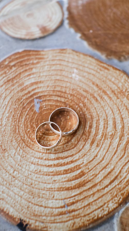 Wedding golden rings placed on wooden surface