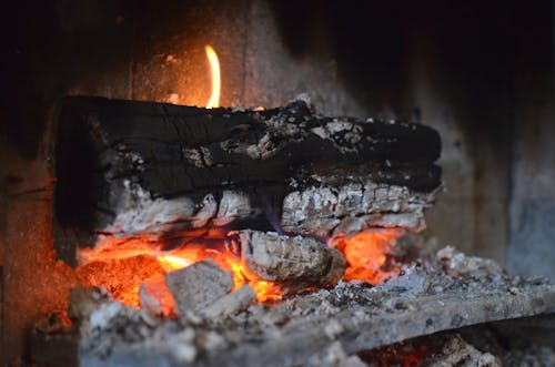 Free Smoldering wood in hot burning fireplace Stock Photo