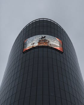 Low-angle view of a modern glass skyscraper featuring an LED display, captured in St. Petersburg.