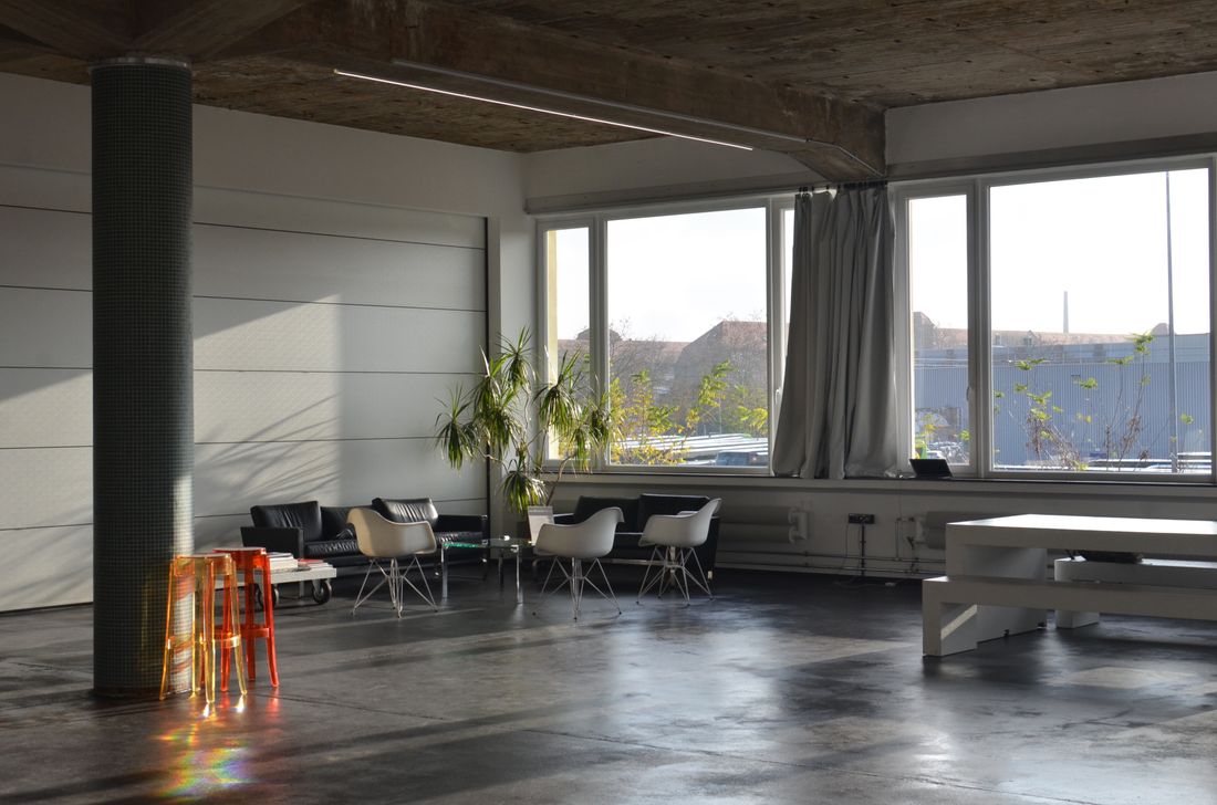 Sunlit corner studio with lounge seating and a work desk — photo by Skylar Kang on Pexels