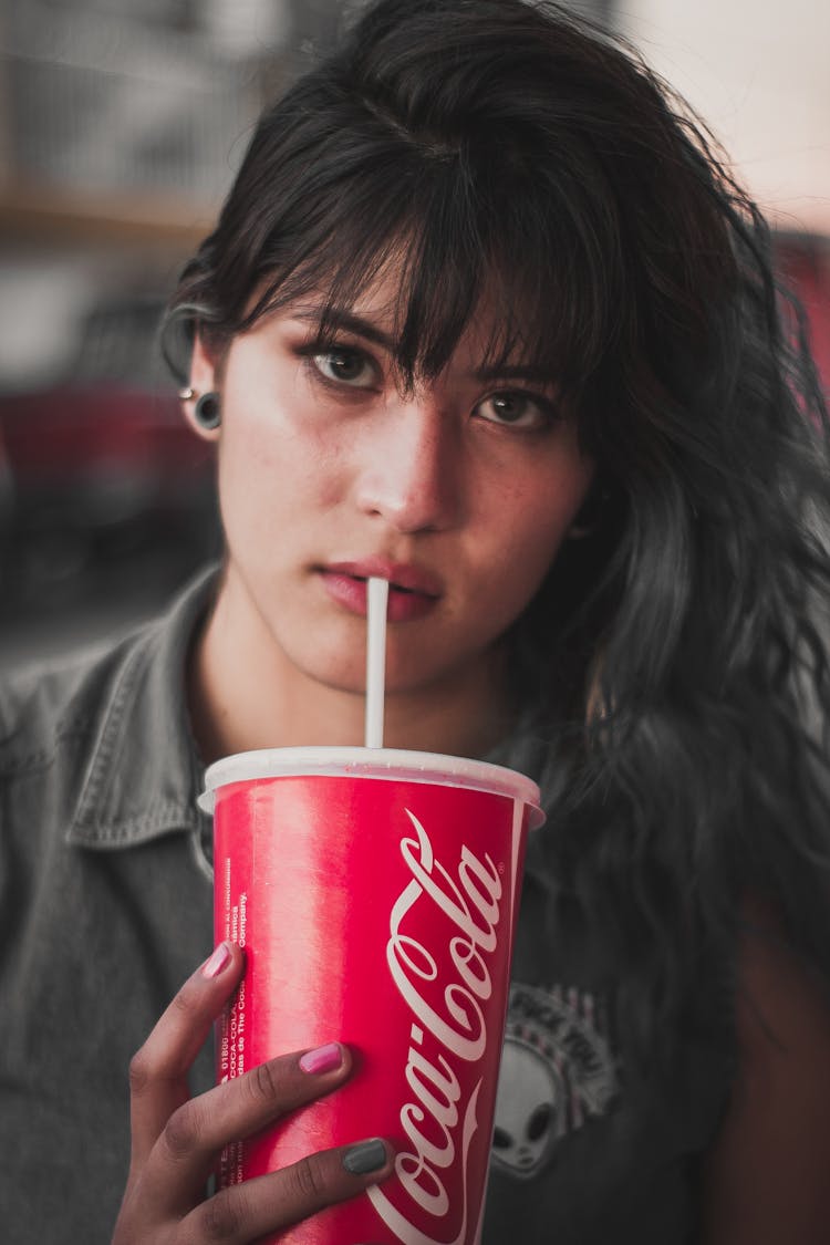 A Woman Drinking Soda