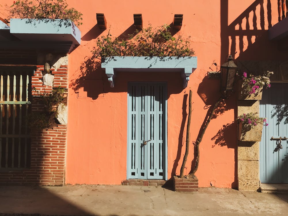 Blue Wooden Door on Brown Concrete Building