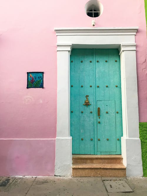 Turquoise Wooden Door on Pink Concrete Wall