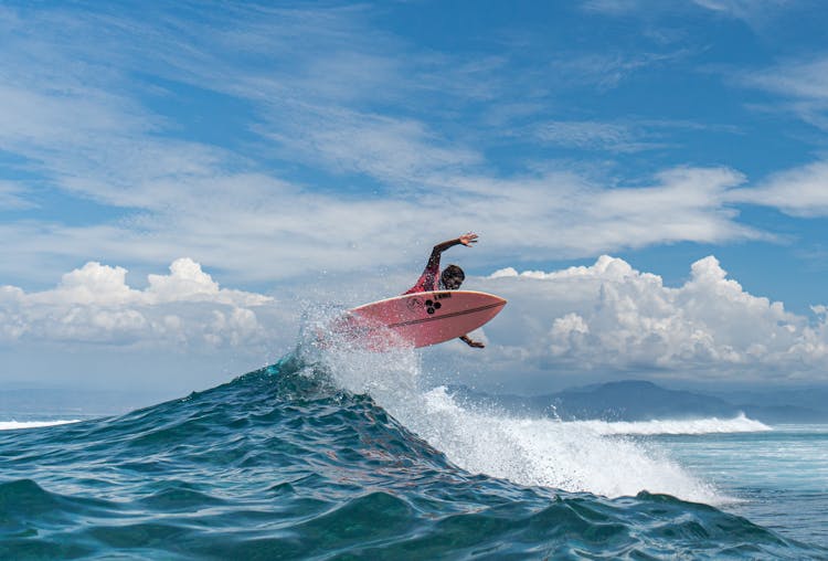 Black Surfer Practicing Extreme Sport Above Ocean Wave