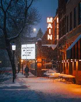 A person walks past a snow-covered theater on a winter night in Minneapolis, MN.