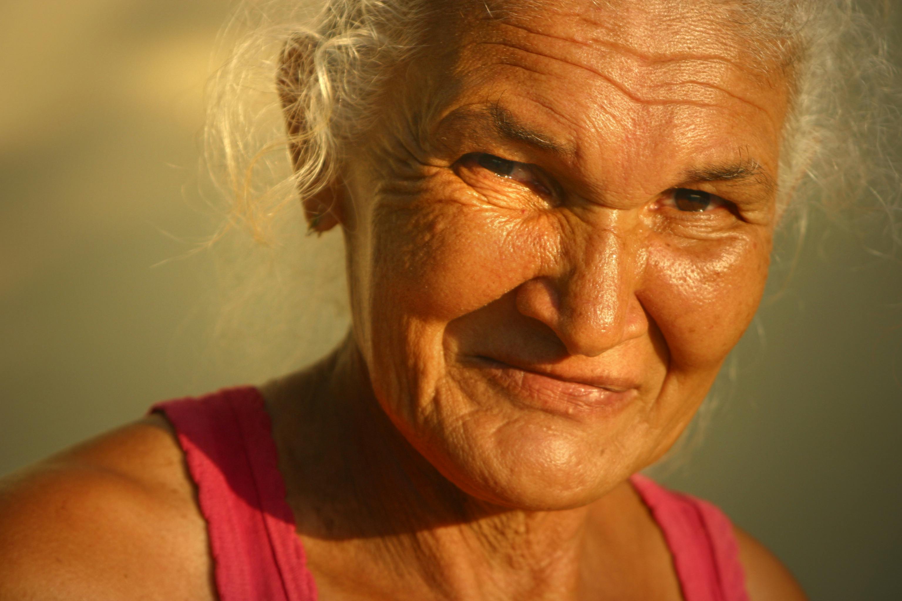 woman in red tank top smiling