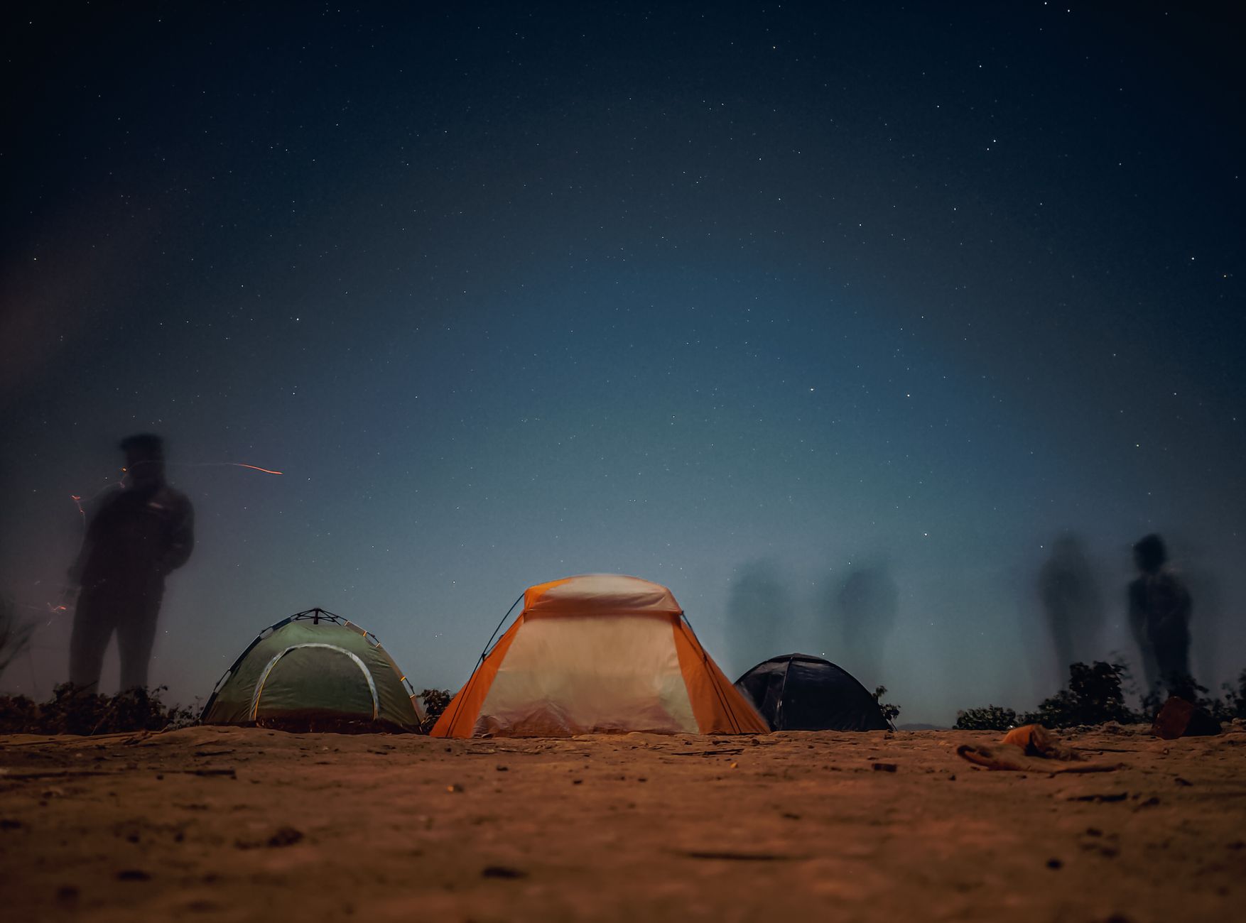 backpacker sleeping under stars wilderness