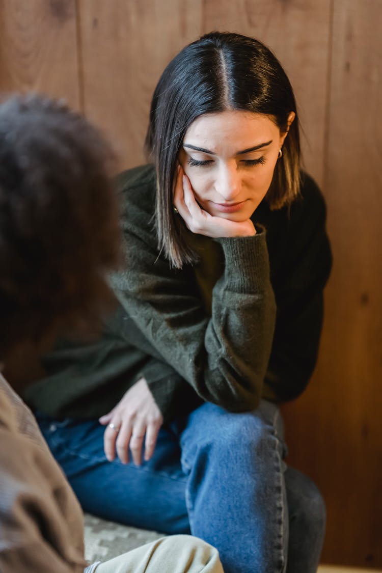 Upset Woman Listening To Friend Sitting Nearby